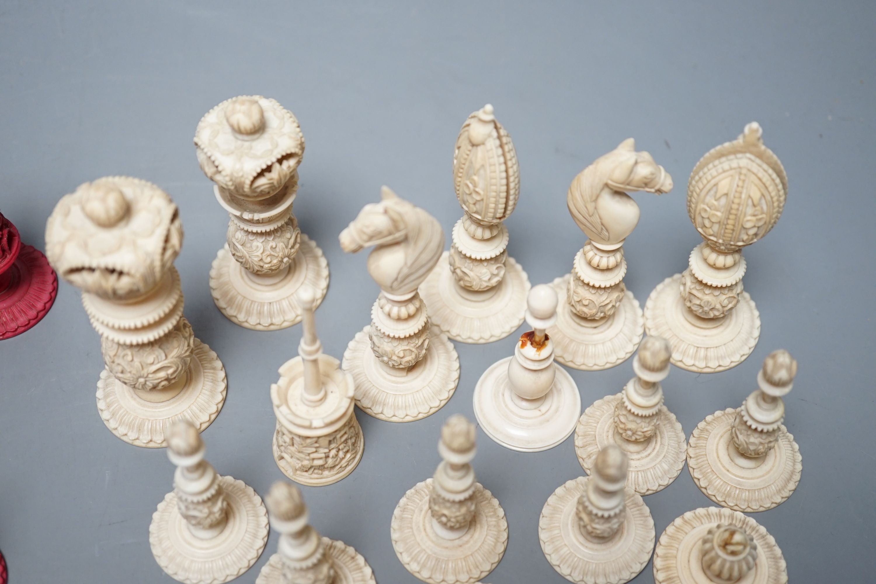 A 19th century Chinese export Burmese pattern carved and stained ivory chess set, one white pawn associated